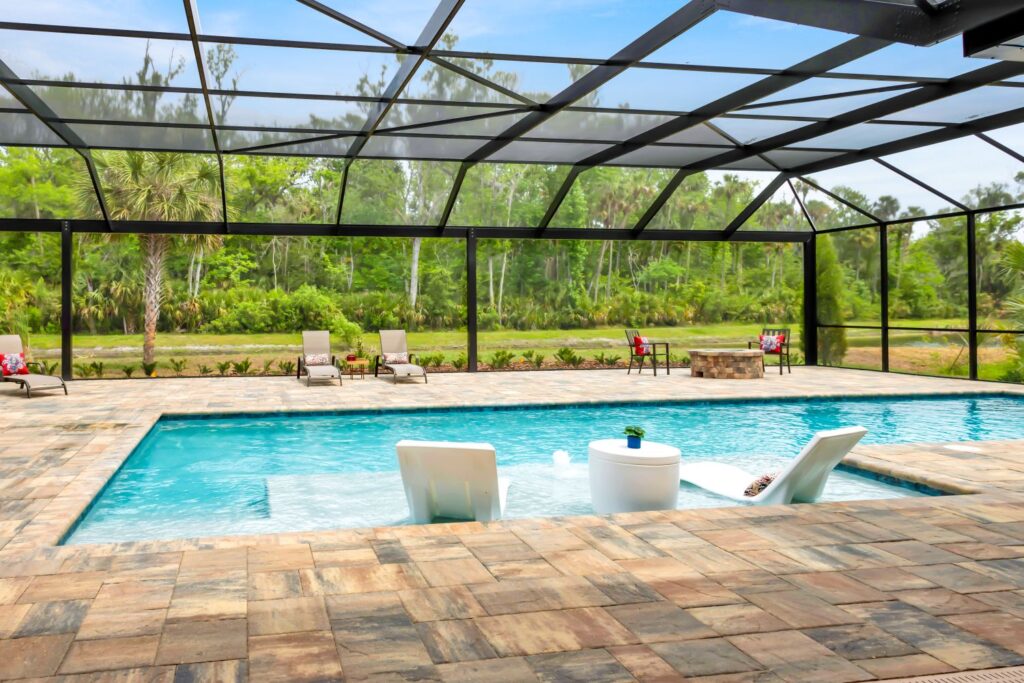 built in pool with wading deck and screen enclosure