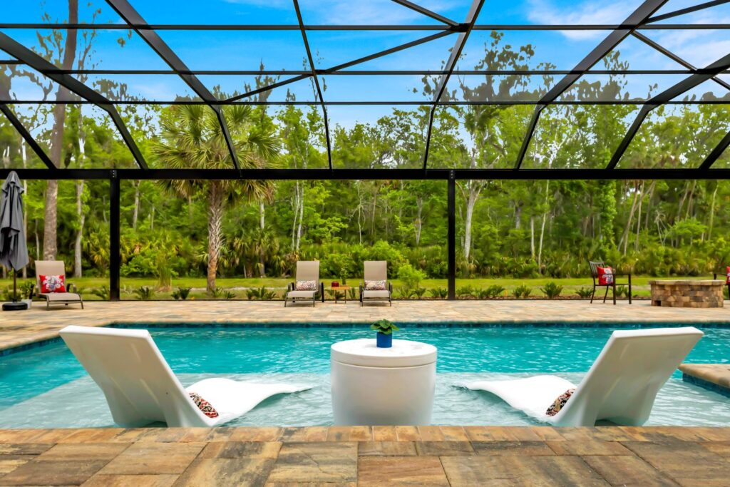 built in pool with wading deck and screen enclosure