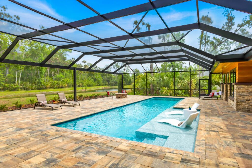 built in pool with wading deck and screen enclosure