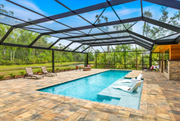 built in pool with wading deck and screen enclosure