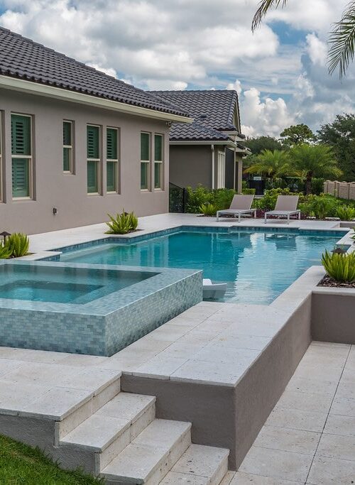 luxury pool with wading deck and whirlpool spa