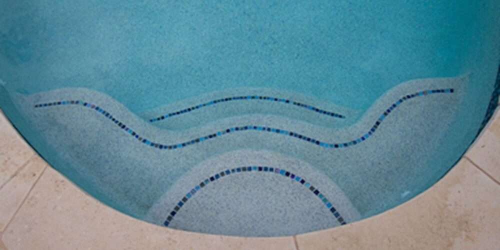 pool steps with curve and wavy shapes appear at the ledge of the pool