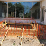 spa installation framed with wood beams behind home